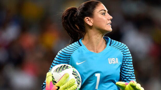 Hope Solo is seen holding a soccer ball wearing a blue USA jersey, HD Desktop Wallpaper