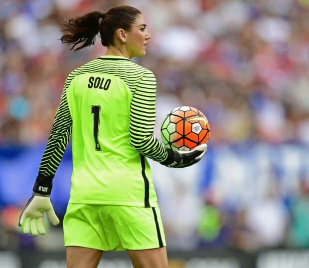 Hope Solo is preparing to throw a soccer ball during a match, HD Desktop Wallpaper