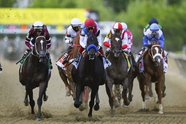 A close up of a horse race with jockeys riding on the track fiercely, 2K Desktop Wallpaper