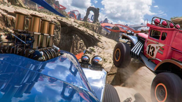 Two Hot Wheels cars race on a looping desert track with rocky arches and blue sky, 4K Desktop Wallpaper