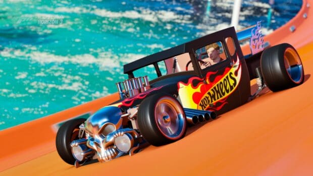 A hot wheels car with flames races on an orange track near water, HD Desktop Wallpaper