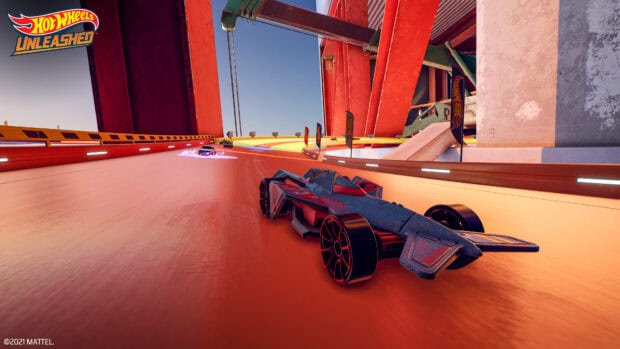 A Hot Wheels car races on an orange track under red bridge structures, 4K Desktop Wallpaper