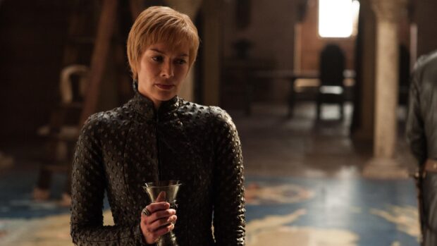 A House Lannister character is holding a goblet standing in a dimly lit room, 4K Desktop Wallpaper