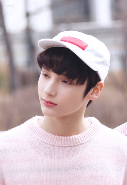 A close up of Huening Kai wearing a white cap and pink sweater, HD Phone Wallpaper