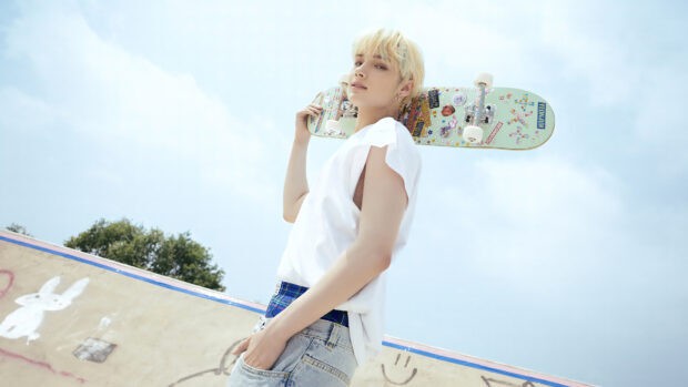 Huening Kai holding a decorated skateboard with a confident expression, 4K Desktop Wallpaper