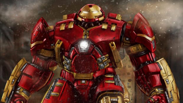 The Hulkbuster stands ready with a glowing arc reactor in a smoky battlefield, 2K Desktop Wallpaper