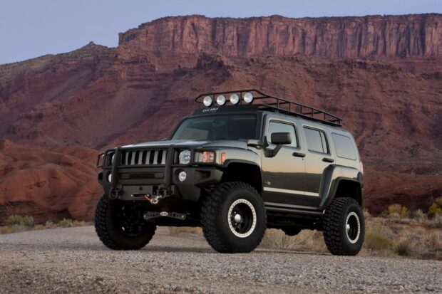 A Hummer H3 parked on a gravel road with rocky cliffs in the background, HD Desktop Wallpaper