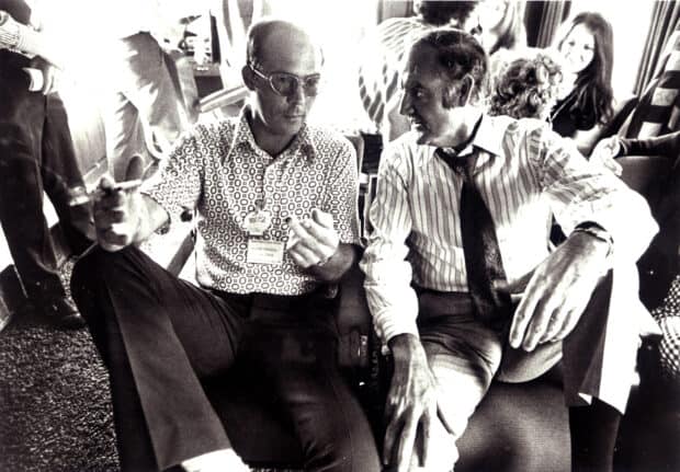 Hunter S Thompson is sitting and talking with another man in a casual setting, HD Desktop Wallpaper