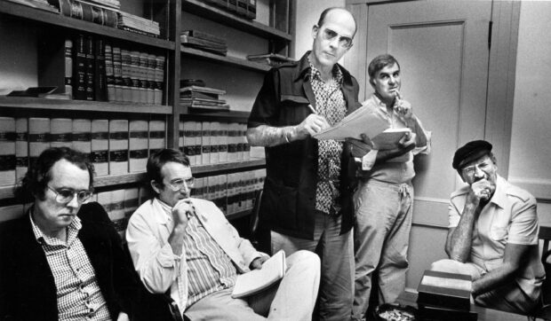 Hunter S Thompson with his colleagues discussing documents in a library room, 2K Desktop Wallpaper