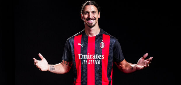 Ibrahimovic smiles wearing a red and black AC Milan jersey with arms open wide, 2K Desktop Wallpaper