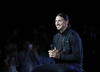 Zlatan Ibrahimovic smiles while holding a microphone during an event, HD Desktop Wallpaper