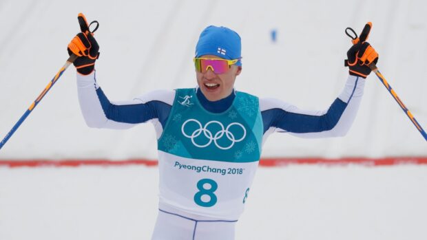 Iivo Niskanen is raising his ski poles after a competition, HD Desktop Wallpaper