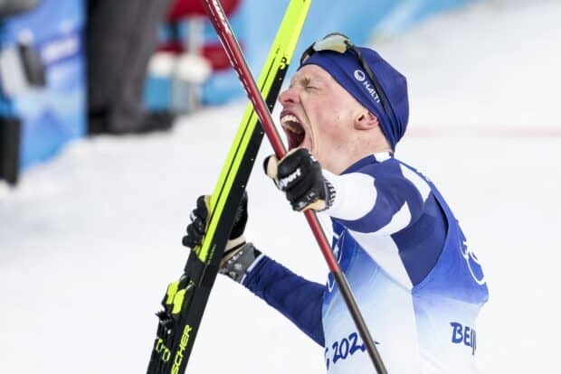 Iivo Niskanen passionately celebrates with his skis during a winter sports event, 2K Desktop Wallpaper