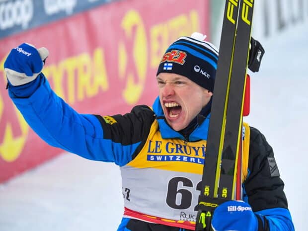 Iivo Niskanen passionately celebrates his ski competition win holding skis, HD Desktop Wallpaper