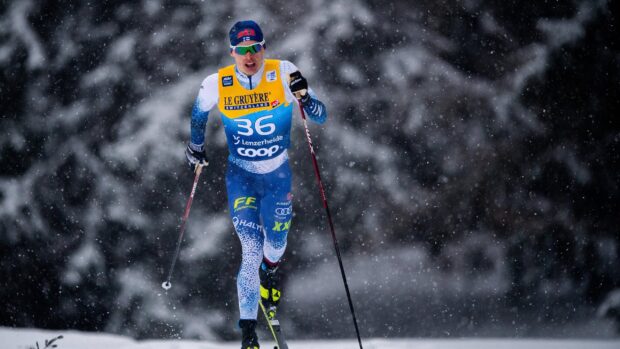 Iivo Niskanen is skiing during a snowy winter race, 2K Desktop Wallpaper