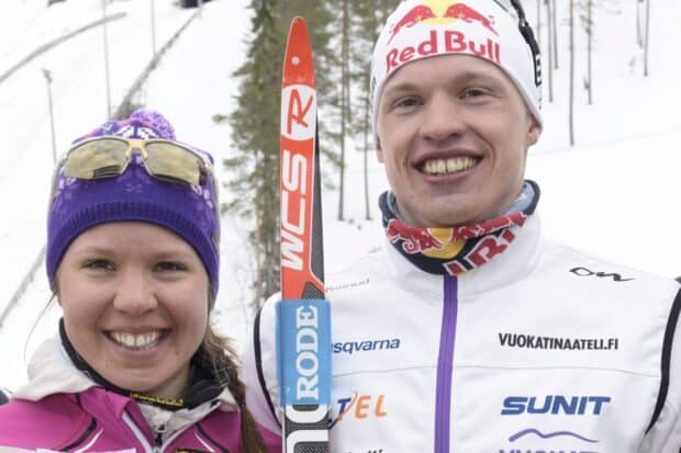 Iivo Niskanen smiles while standing next to a female skier in winter gear, HD Desktop Wallpaper
