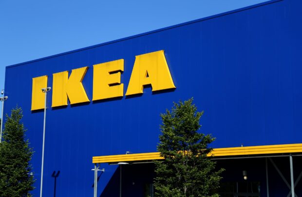 The Ikea logo is displayed on a bright blue building facade with trees nearby, 2K Desktop Wallpaper
