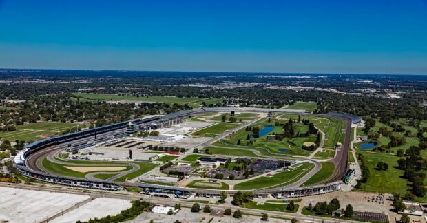 Aerial view of Indianapolis Motor Speedway showcasing the race track and surrounding area under clear skies, HD Desktop Wallpaper