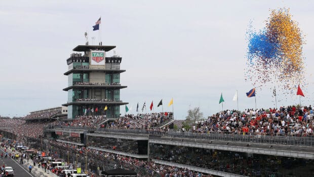 Crowds celebrate at Indianapolis Motor Speedway with balloons and flags, 2K Desktop Wallpaper