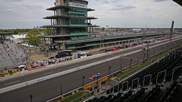 A race car drives on the track at Indianapolis Motor Speedway during an event, 2K Desktop Wallpaper