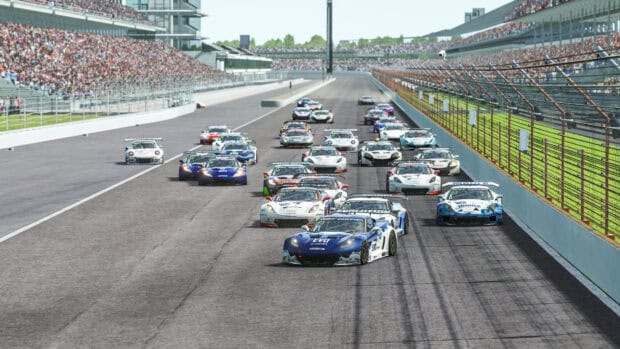 A group of sports cars racing on the Indianapolis Motor Speedway track in front of a large audience, 4K Desktop Wallpaper