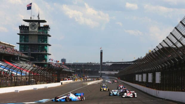 Racing cars compete at Indianapolis Motor Speedway with a crowd in the stands, HD Desktop Wallpaper