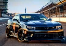 A sleek black car with Indianapolis Motor Speedway logo parked on the racetrack, HD Desktop Wallpaper