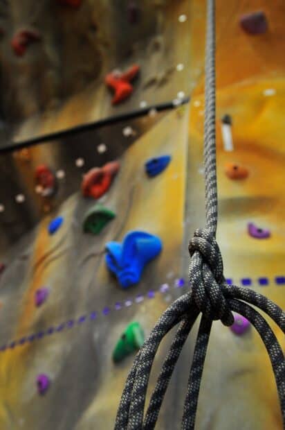 This image shows indoor rock climbing ropes with vibrant holds on the wall for climbers, HD Mobile Wallpaper