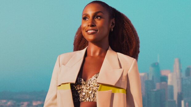 A confident woman from Insecure Tv Series smiling against a city skyline, 4K Desktop Wallpaper