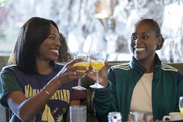 Two women from Insecure TV series sharing drinks and smiling, HD Desktop Wallpaper