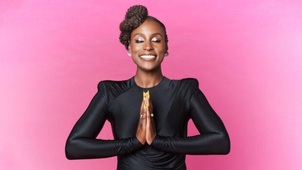 A smiling woman with styled hair and bright nails poses in front of a pink background from Insecure Tv Series, HD Desktop Wallpaper