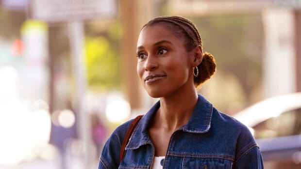 A woman from Insecure tv series smiles softly in an outdoor setting, HD Desktop Wallpaper