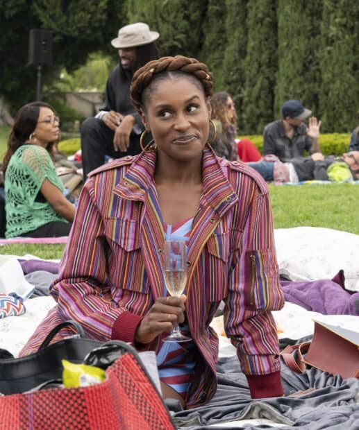 A woman from Insecure TV series enjoys a picnic while holding a glass of champagne, HD Phone Wallpaper