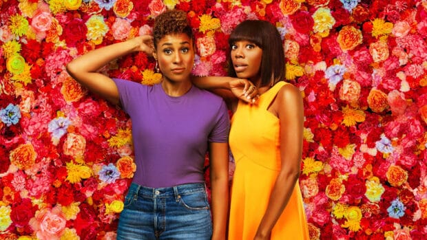 Two women from Insecure Tv Series stand before colorful flowers, 4K Desktop Wallpaper