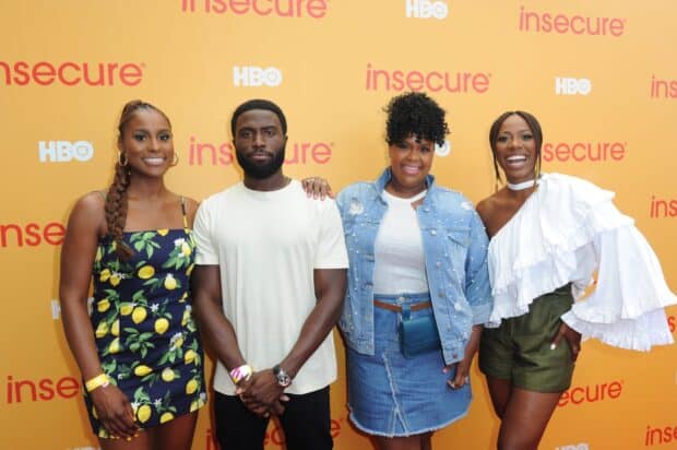The Insecure tv series cast poses together at an event with a bright yellow backdrop, 2K Desktop Wallpaper