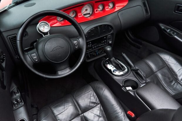 The interior of a Plymouth Prowler car highlights its black leather seats and dashboard details, HD Desktop Wallpaper