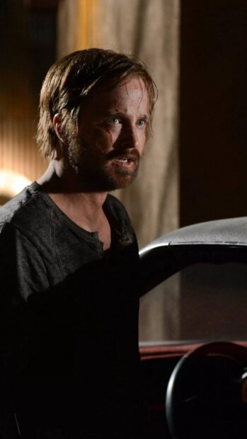 Aaron Paul looks determined and injured in a dark setting, 2K Phone Wallpaper