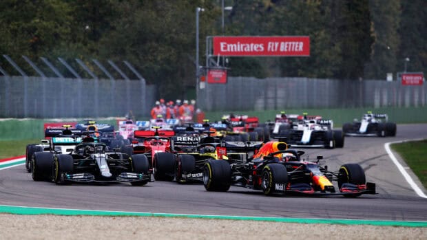 F1 race wallpapers showing multiple cars battling on a race track, HD Desktop Wallpaper