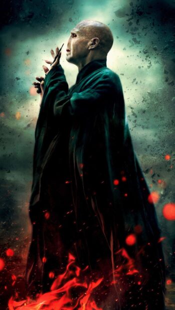 Ralph Fiennes stands with focused expression among fiery embers, HD Phone Wallpaper