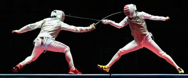 Two athletes fencing with swords during a match, 4K Desktop Wallpaper