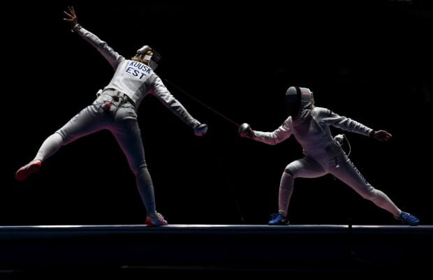 Two fencers compete in a dramatic fencing match under dark lighting, HD Desktop Wallpaper