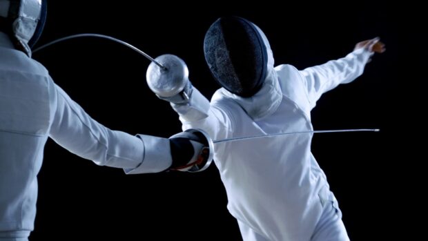Two fencers engage in a close combat match with swords, HD Desktop Wallpaper