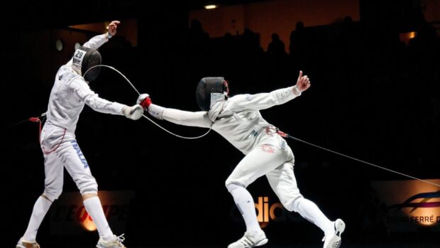 Two fencers engage in a rapid fencing duel during a match, HD Desktop Wallpaper