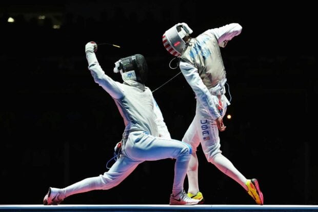 Two athletes engage in an intense fencing duel during a match, HD Desktop Wallpaper