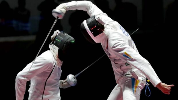 Two fencers engaging in a competitive fencing duel wearing protective gear, HD Desktop Wallpaper
