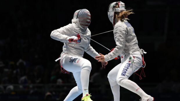 Two athletes compete in an intense fencing match during a competition, HD Desktop Wallpaper