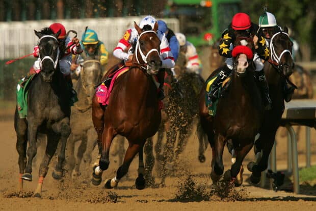 A group of jockeys riding horses fiercely during a race, 2K Desktop Wallpaper