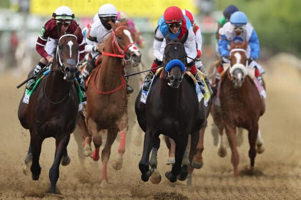 Several jockeys ride horses during a horse racing event in the dirt track, HD Desktop Wallpaper