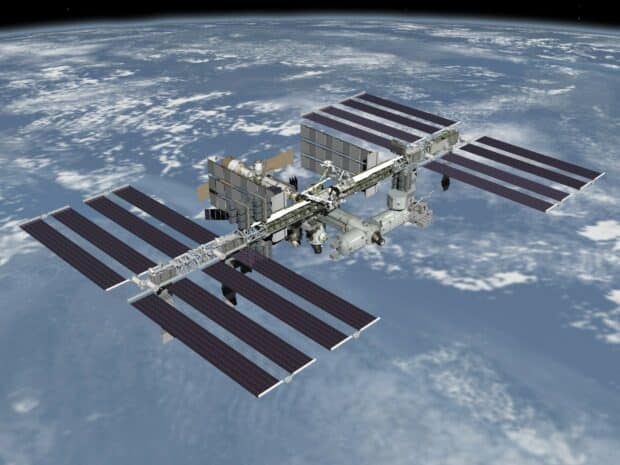The space station is orbiting above the planet Earth with solar panels extended, HD Desktop Wallpaper
