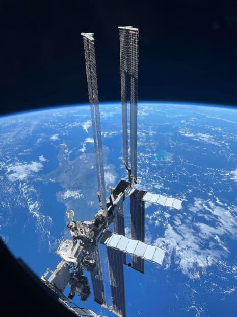 The international space station orbits Earth with solar panels visible in the image, HD Mobile Wallpaper